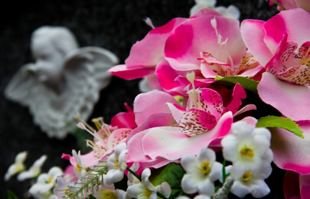 Flowers beside a stone angel